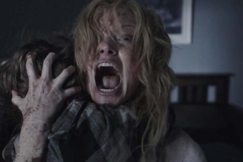 The Babadook 2014 Movie Scene Essie Davis as Amelia holding her son and screaming at the monster