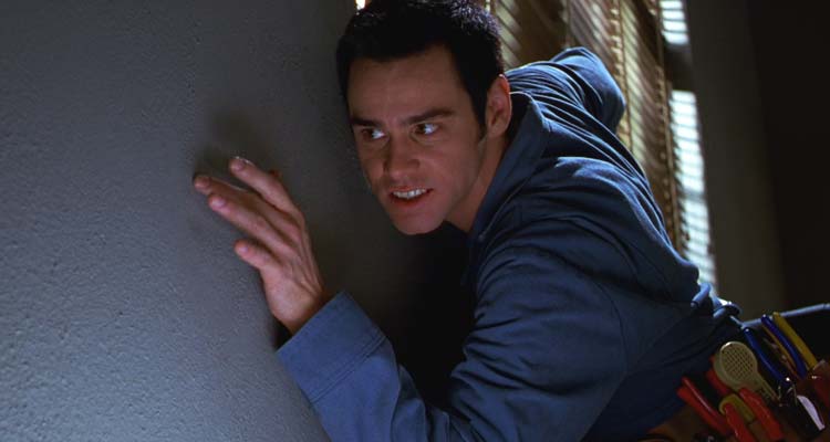 The Cable Guy 1996 Movie Scene Jim Carrey as Chip looking for the right spot on the wall to install cable tv