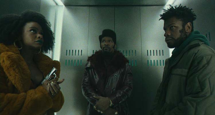 They Cloned Tyrone 2023 Movie Scene John Boyega as Fontaine, Jamie Foxx as Slick Charles, and Teyonah Parris as Yo-Yo in an elevator