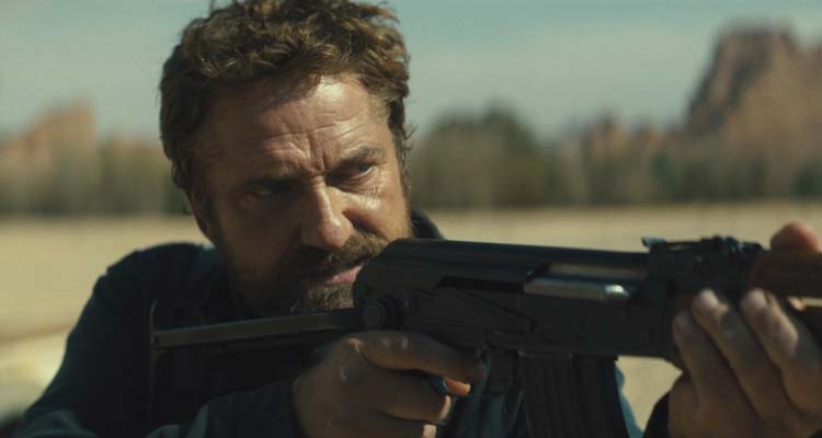 Kandahar 2023 Movie Scene Gerard Butler as Tom Harris firing his gun at the bad guys