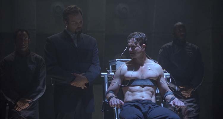 Impostor 2001 Movie Scene Gary Sinise as Spencer Olham tied to a chair and interrogated by the commander of ESA forces Vincent D'Onofrio as Hathaway