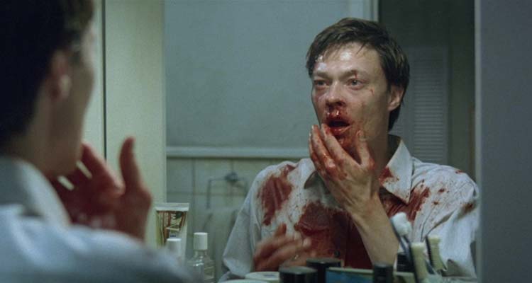Next Door AKA Naboer 2005 Movie Scene Kristoffer Joner as John looking at his bloody face in the mirror