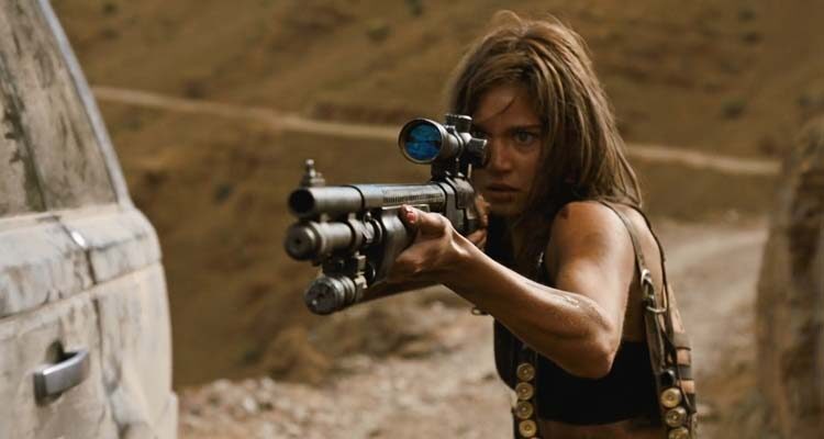 Revenge 2017 Movie Scene Matilda Anna Ingrid Lutz as Jen holding a Mossberg 590DA1 shotgun with scope attached and waiting for Dimitri