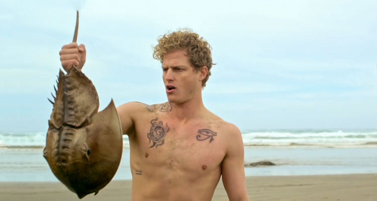 Crabs 2021 Movie Scene Dash Pomerantz as Sequoia holding a killer horseshoe crab he found on the beach