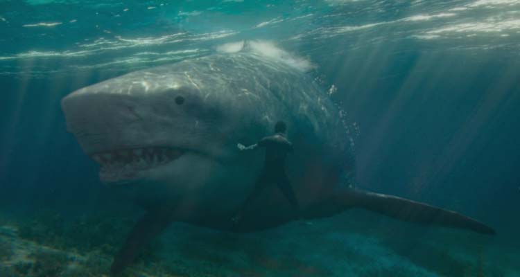 Meg 2 The Trench 2023 Movie Scene A giant megalodon shark swimming right past Jing Wu as Jiuming Zhang