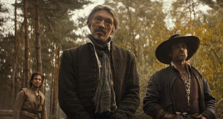 The Three Musketeers D'Artagnan 2023 Movie Scene Vincent Cassel as Athos, Romain Duris as Aramis and François Civil as Charles d'Artagnan standing in the forest after defeating Cardinal Richelieu soldiers