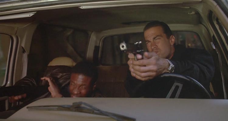 Marked for Death 1990 Movie Scene Steven Seagal as John Hatcher shooting from his vehicle with Keith David as Max ducking to avoid the oncoming fire