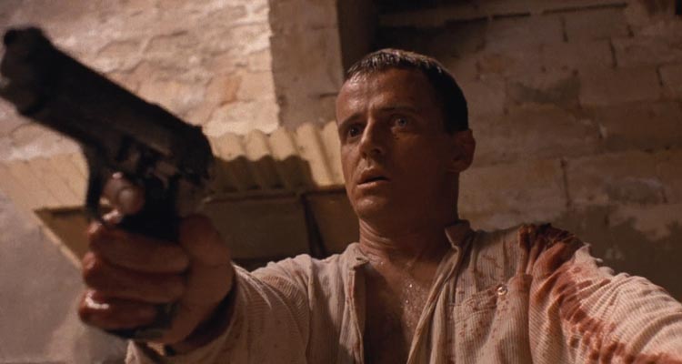 The Assignment 1997 Movie Scene Aidan Quinn as Annibal Ramirez holding a gun after he just killed a man