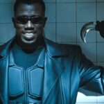 Blade 1998 Movie Scene Wesley Snipes as Blade in a leather suit wearing sunglasses and holding a special boomerang weapon