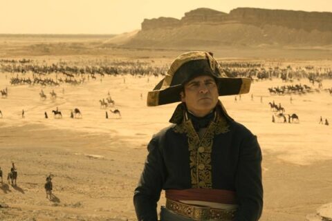 Napoleon 2023 Movie Scene Joaquin Phoenix as Napoleon Bonaparte in Egypt looking at the pyramids with his army advancing in the background