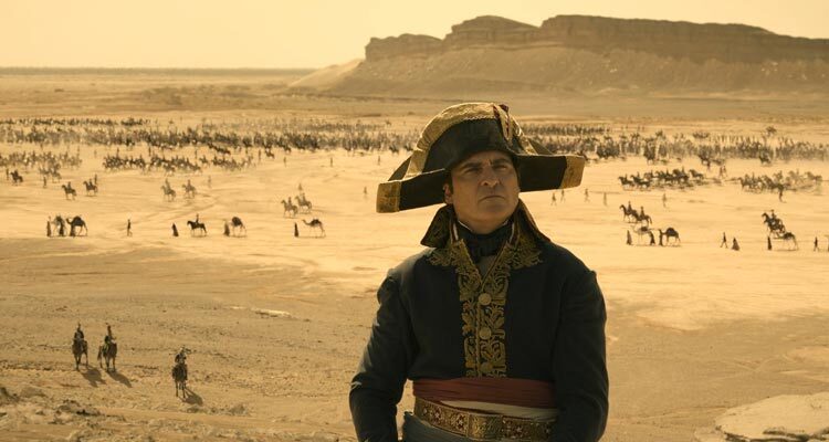 Napoleon 2023 Movie Scene Joaquin Phoenix as Napoleon Bonaparte in Egypt looking at the pyramids with his army advancing in the background