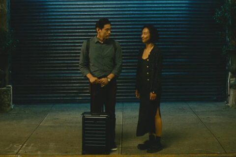 Past Lives 2023 Movie Scene Greta Lee as Nora/Na Young and Teo Yoo as Hae Sung saying goodbye as he flies back to South Korea