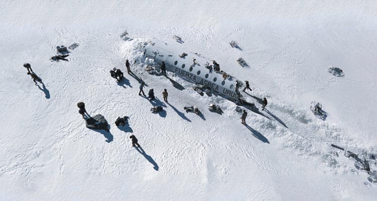 Society of the Snow 2023 Movie Scene Survivors of the plane crash standing next to the wreckage