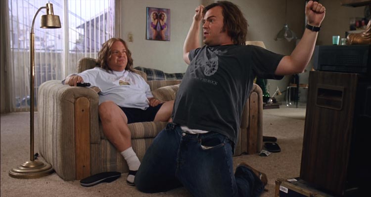Tenacious D in The Pick of Destiny 2006 Movie Scene Jack Black as JB practicing a power slide under Kyle Gass as KG instructions