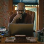 American Fiction 2023 Movie Scene Jeffrey Wright as Thelonious Monk Ellison writing his book My Pafology as a joke