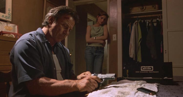City of Industry 1997 Movie Scene Harvey Keitel as Roy Egan cleaning his gun while Famke Janssen as Rachel is watching him