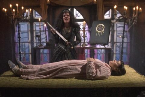 Night of the Demons 2 1994 Movie Scene Amelia Kinkade as Angela in her demonic form holding a sacrificial knife over Merle Kennedy as Mouse