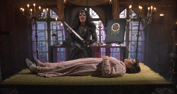 Night of the Demons 2 1994 Movie Scene Amelia Kinkade as Angela in her demonic form holding a sacrificial knife over Merle Kennedy as Mouse