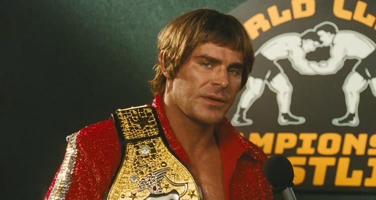 The Iron Claw 2023 Movie Scene Zac Efron as Kevin Von Erich holding his belt during an interview