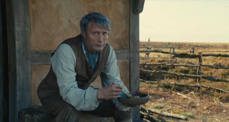 The Promised Land AKA Bastarden 2023 Movie Scene Mads Mikkelsen as Ludvig Kahlen eating oatmeal in front of his house in the Danish Jutland