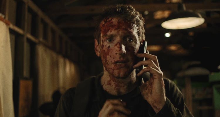 You Might Be The Killer 2018 Movie Scene Fran Kranz as Sam covered in blood talking over the phone