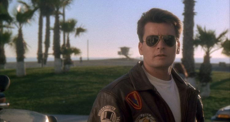 Hot Shots 1991 Movie Scene Charlie Sheen as Topper Harley wearing sun glasses and a leather jacket just like Tom Cruise in Top Gun