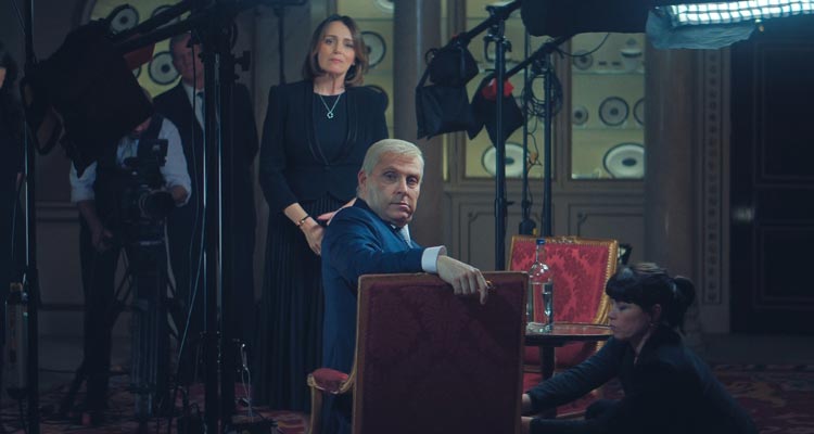 Scoop 2024 Movie Scene Rufus Sewell as Prince Andrew getting ready for the interview with Keeley Hawes as Amanda Thirsk standing in the background