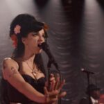 Back to Black 2024 Movie Scene Marisa Abela as Amy Winehouse singing on stage