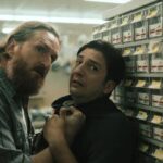 LaRoy Texas 2023 Movie Scene Brannon Cross as Tiller holding John Magaro as Ray in his store