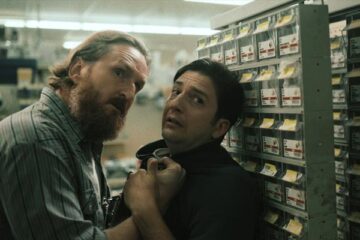 LaRoy Texas 2023 Movie Scene Brannon Cross as Tiller holding John Magaro as Ray in his store