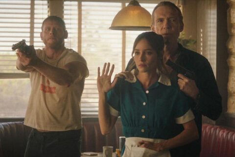 The Last Stop in Yuma County 2023 Movie Scene Richard Brake as Beau holding a gun pointed at Jocelin Donahue as Charlotte in a diner next to Nicholas Logan as Travis