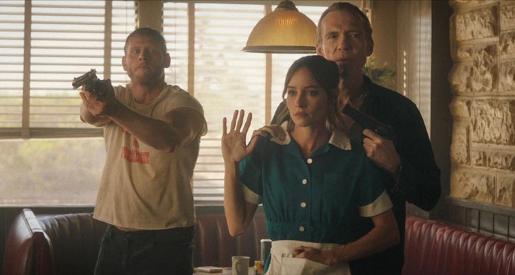 The Last Stop in Yuma County 2023 Movie Scene Richard Brake as Beau holding a gun pointed at Jocelin Donahue as Charlotte in a diner next to Nicholas Logan as Travis