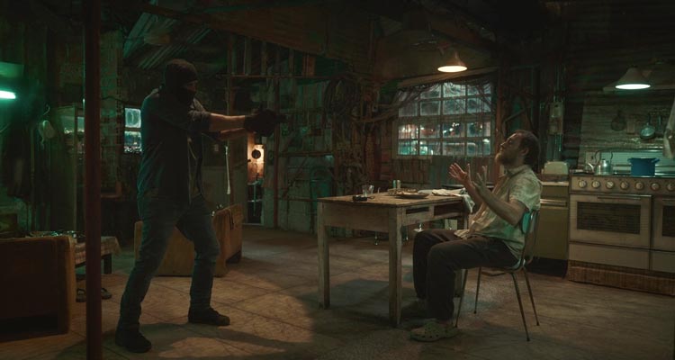 Adagio 2023 Movie Scene Adriano Giannini as Vasco holding a gun pointed at Valerio Mastandrea as Polniuman in his house and asking where is Manuel