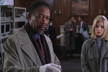 Along Came a Spider 2001 Movie Scene Morgan Freeman as Alex Cross on the crime scene pointing at something with Monica Potter as Jezzie standing in the background