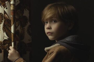 Before I Wake 2016 Movie Scene Jacob Tremblay as Cody standing next to a curtain because it has butterflies