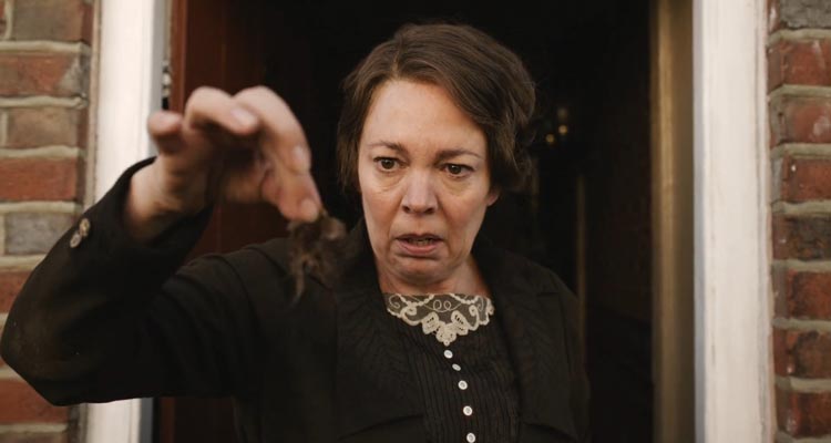 Wicked Little Letters 2023 Movie Scene Olivia Colman as Edith Swan looking at the clump of hair in disgust