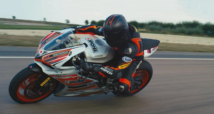 Burn Out 2017 Movie Scene François Civil as Tony riding his motorcycle on the racing track