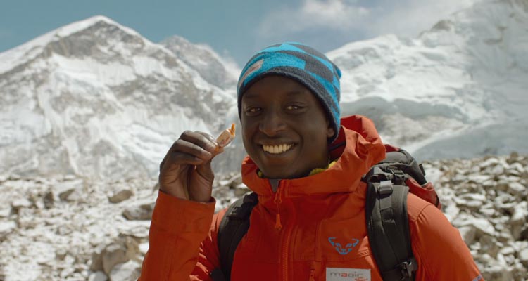 The Climb 2017 Movie Scene Ahmed Sylla as Samy Diakhaté trying to feed candy to an ox close to the Everest