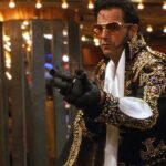 3000 Miles To Graceland 2001 Movie Scene Kevin Costner as Murphy wearing an Elvis costume and holding a shotgun during a casino heist