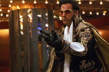3000 Miles To Graceland 2001 Movie Scene Kevin Costner as Murphy wearing an Elvis costume and holding a shotgun during a casino heist