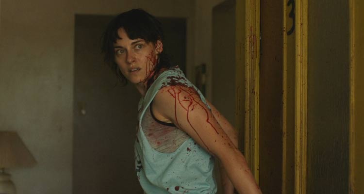 Love Lies Bleeding 2024 Movie Scene Kristen Stewart as Lou covered in blood after Jackie shot Daisy