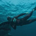 The Last Breath 2024 Movie Scene A big great white shark about to bite Julian Sands as Levi in his red diving suit at the end of the movie