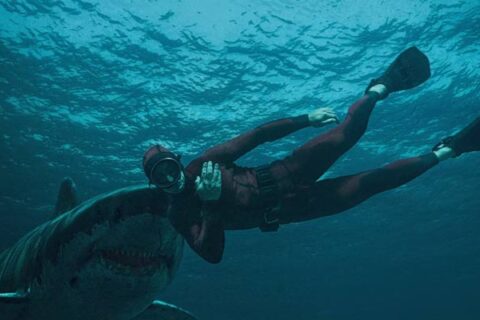 The Last Breath 2024 Movie Scene A big great white shark about to bite Julian Sands as Levi in his red diving suit at the end of the movie