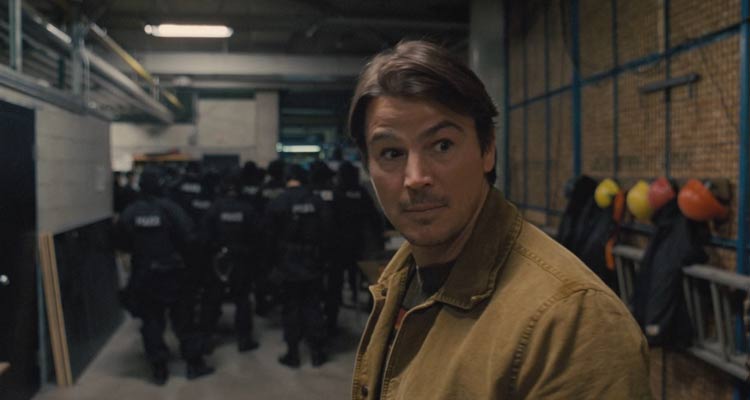 Trap 2024 Movie Scene Josh Hartnett as Cooper surprised at the presence of police at the concert of Lady Raven