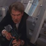 Air Force One 1997 Movie Scene Harrison Ford as President James Marshall holding a machine gun and looking for terrorists on the airplane