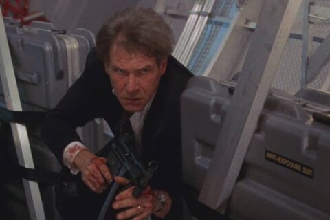 Air Force One 1997 Movie Scene Harrison Ford as President James Marshall holding a machine gun and looking for terrorists on the airplane