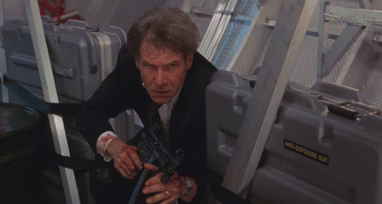 Air Force One 1997 Movie Scene Harrison Ford as President James Marshall holding a machine gun and looking for terrorists on the airplane