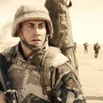 Jarhead 2005 Movie Scene Jake Gyllenhaal as Anthony Swofford in Iraq spotting something in the distance