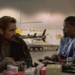 Miami Vice 2006 Movie Scene Colin Farrell as Sonny and Jamie Foxx as Rico in their secret hideout in front of a table full of weapons and ammo