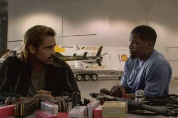 Miami Vice 2006 Movie Scene Colin Farrell as Sonny and Jamie Foxx as Rico in their secret hideout in front of a table full of weapons and ammo